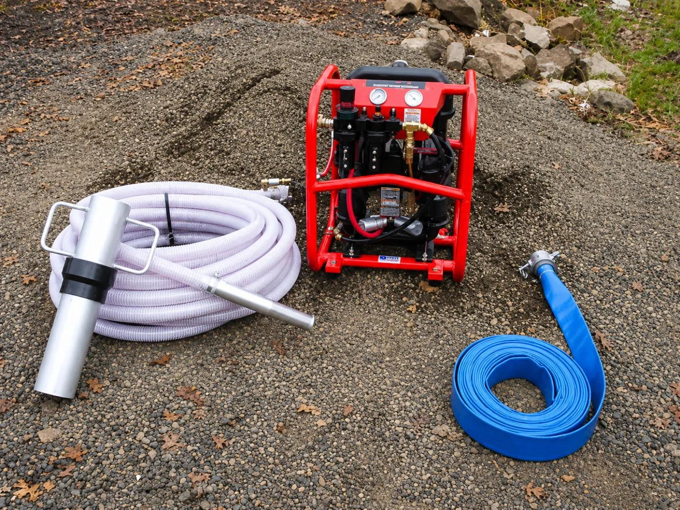 The complete DRE-80 system: pump, 100 ft clear suction hose with Jet Nozzle, borehole sleeve and 75 ft blue discharge hose